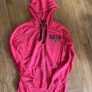 PINK zip-up hoodie.